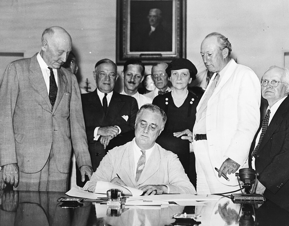 Roosevelt signing the Social Security Act (1935)